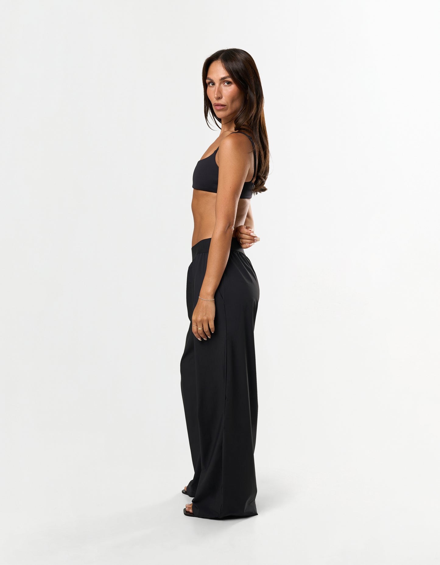Side view of model wearing STAX. Gigi Pants in black showing relaxed straight leg fit