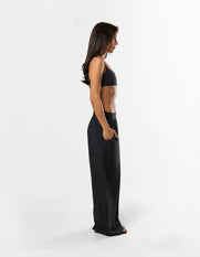 Side profile of STAX. Gigi Pants in black showing relaxed straight leg fit