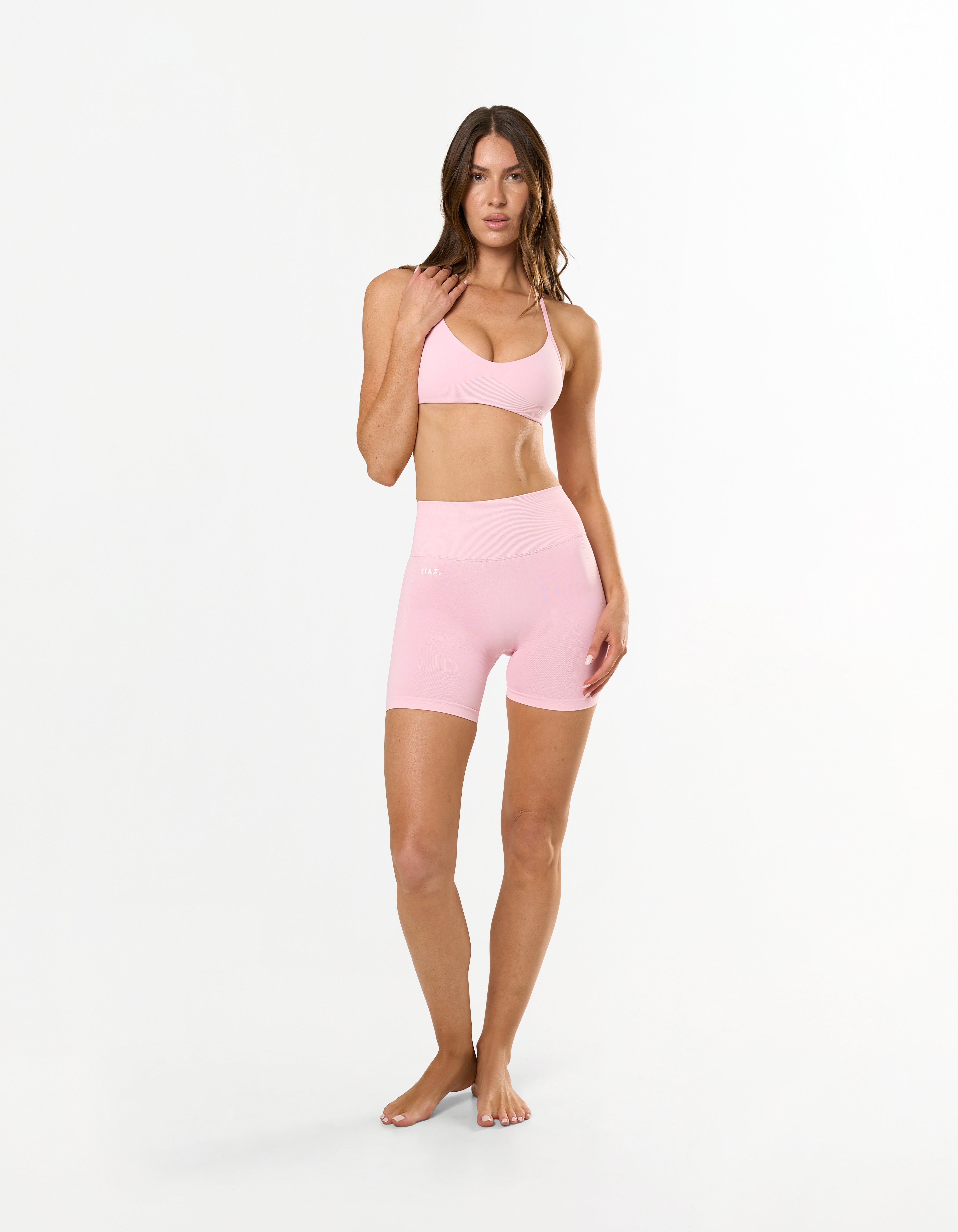 Front profile of STAX. Premium Seamless Skulpt Bralette in Pink showing Strappy halter neck design