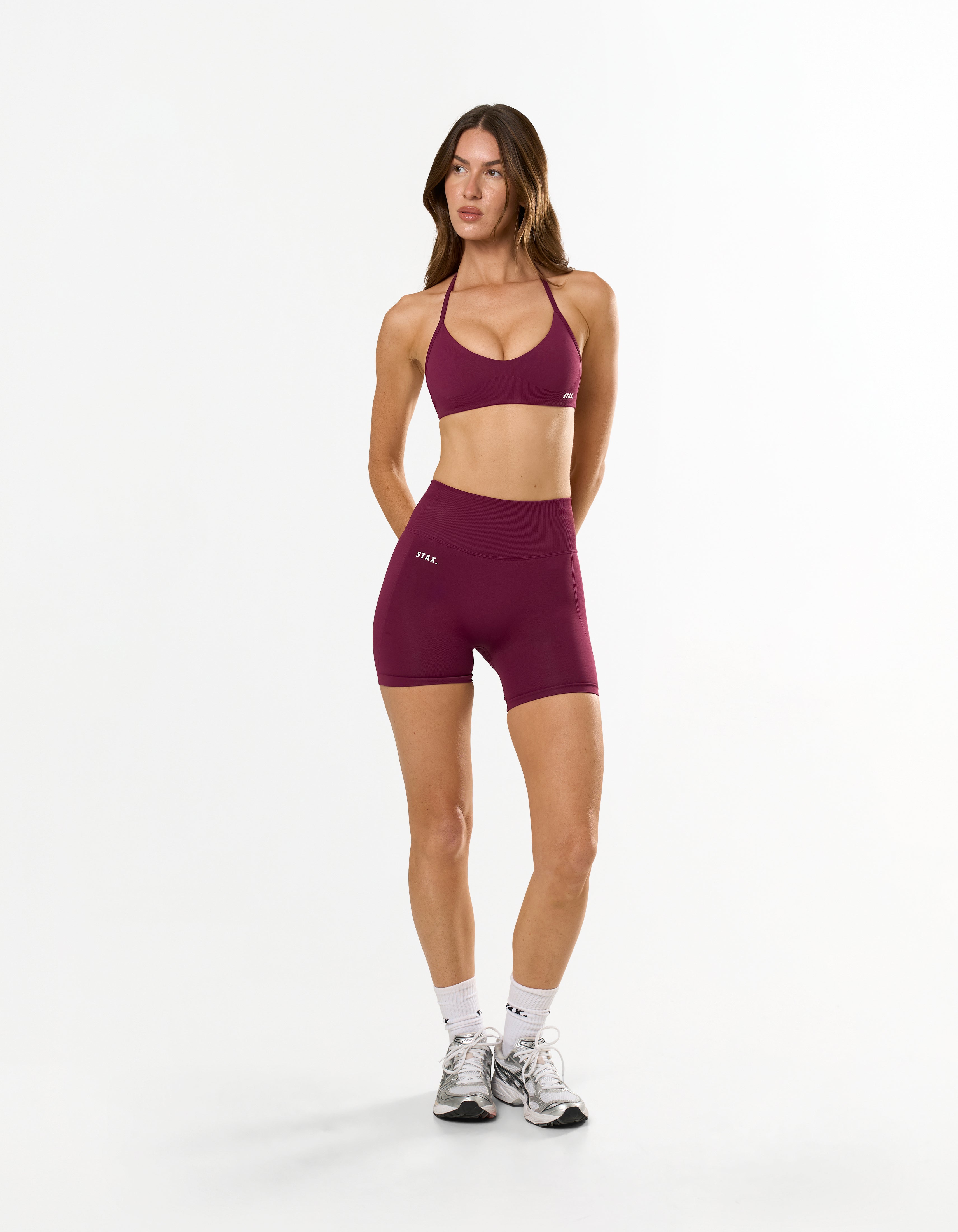 Front view of model wearing STAX. Premium Seamless Skulpt Midi Bike Shorts   and matching strappy halter neck bralette
