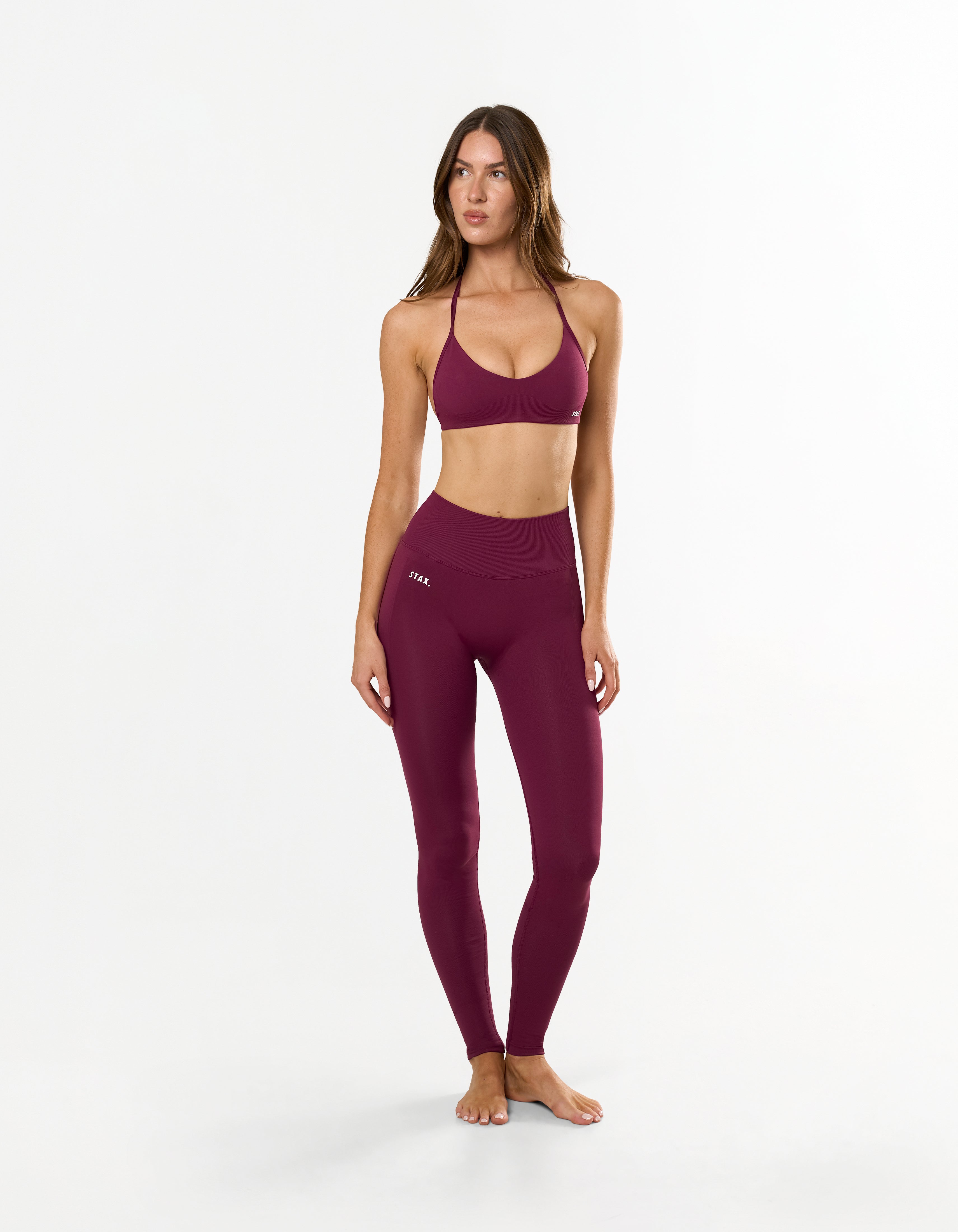 Front profile of STAX. Premium Seamless Skulpt Bralette in Burgundy with compressive fit and strappy halter neck design