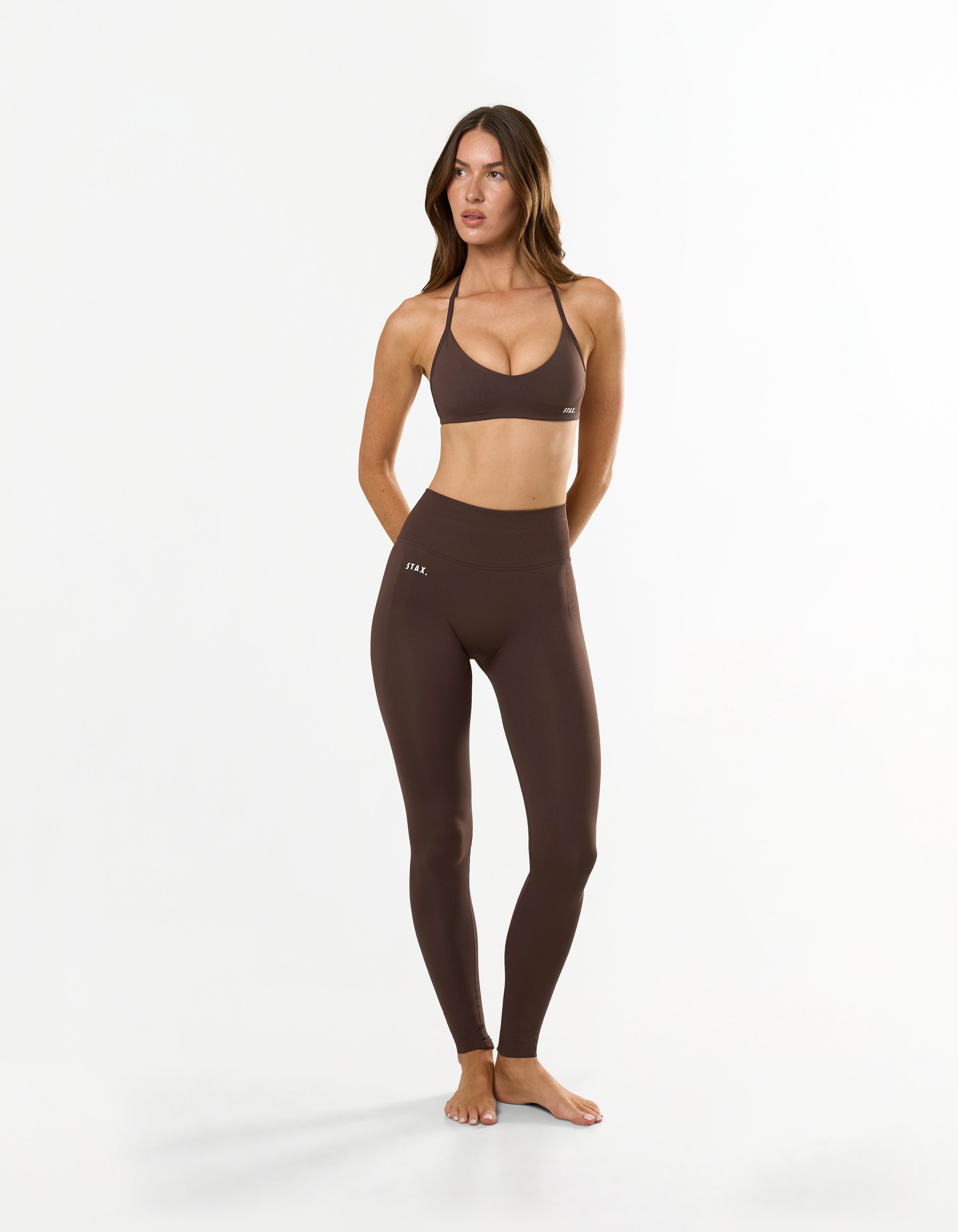 Front view of model wearing STAX. Premium Seamless Skulpt Tights in Brown premium nylon spandex fabric with printed silicone logo and compressive waistband 