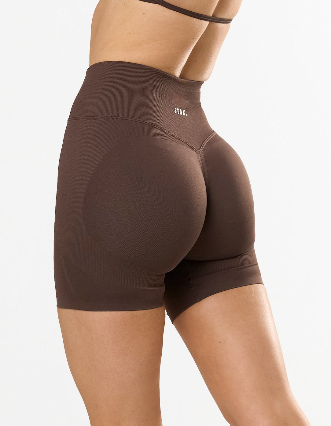 STAX. Premium Seamless Skulpt Midi Bike Shorts in Brown showing flattering invisible scrunch detail 