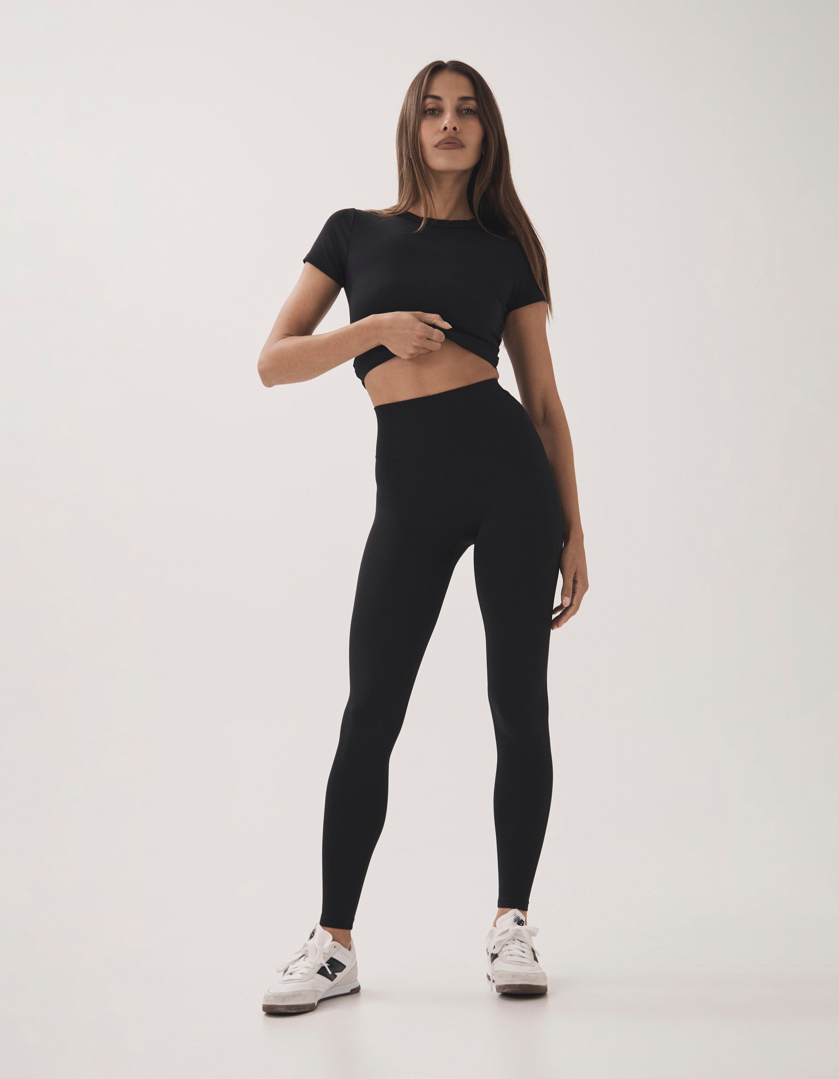 Front view of model wearing STAX. Full Length Tights Airlyte in Black with matching Fitted tee airlyte in black
