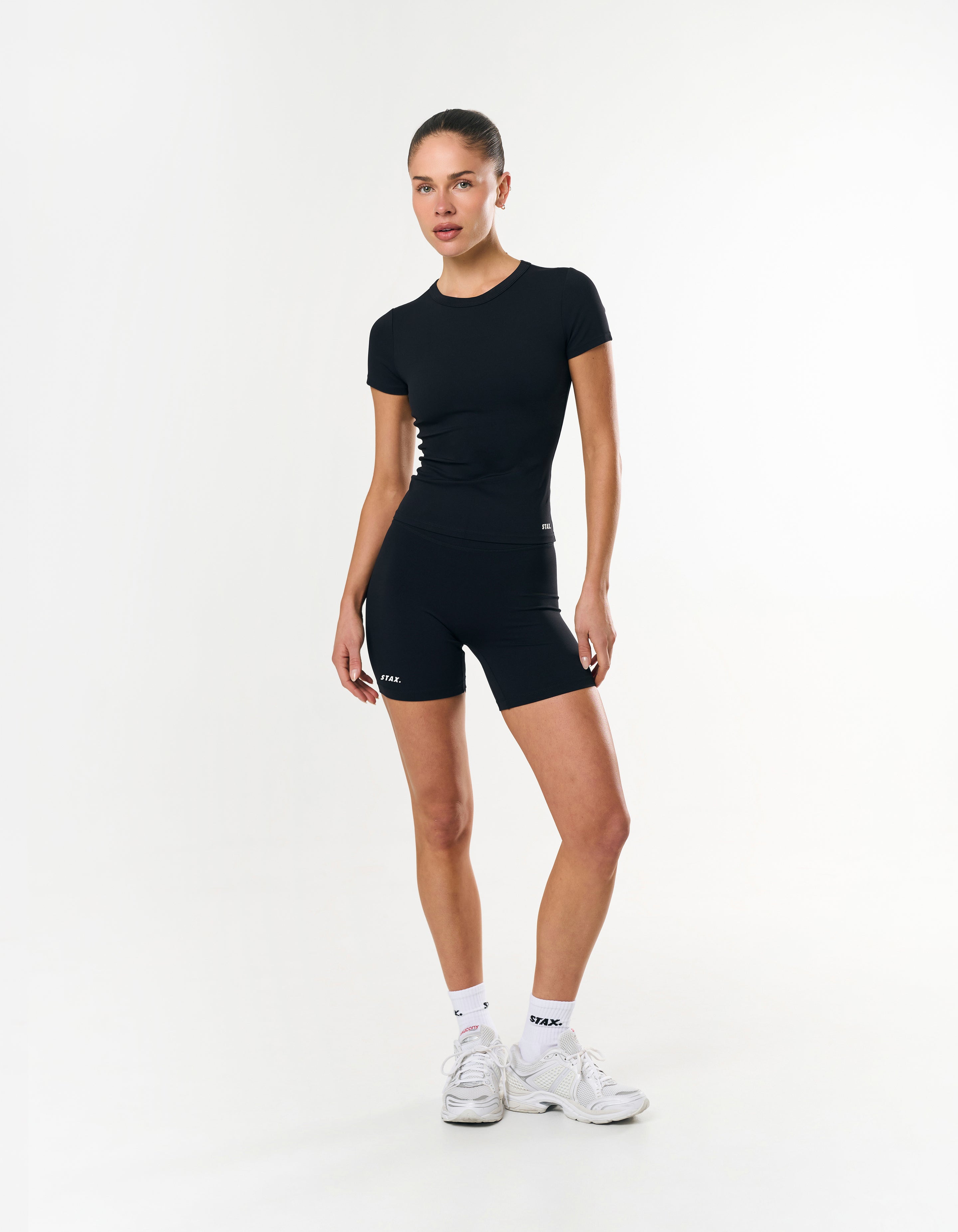 Front view of model wearing STAX. Midi Bike Shorts in Airlyte in Black with matching fitted Tee Airlyte