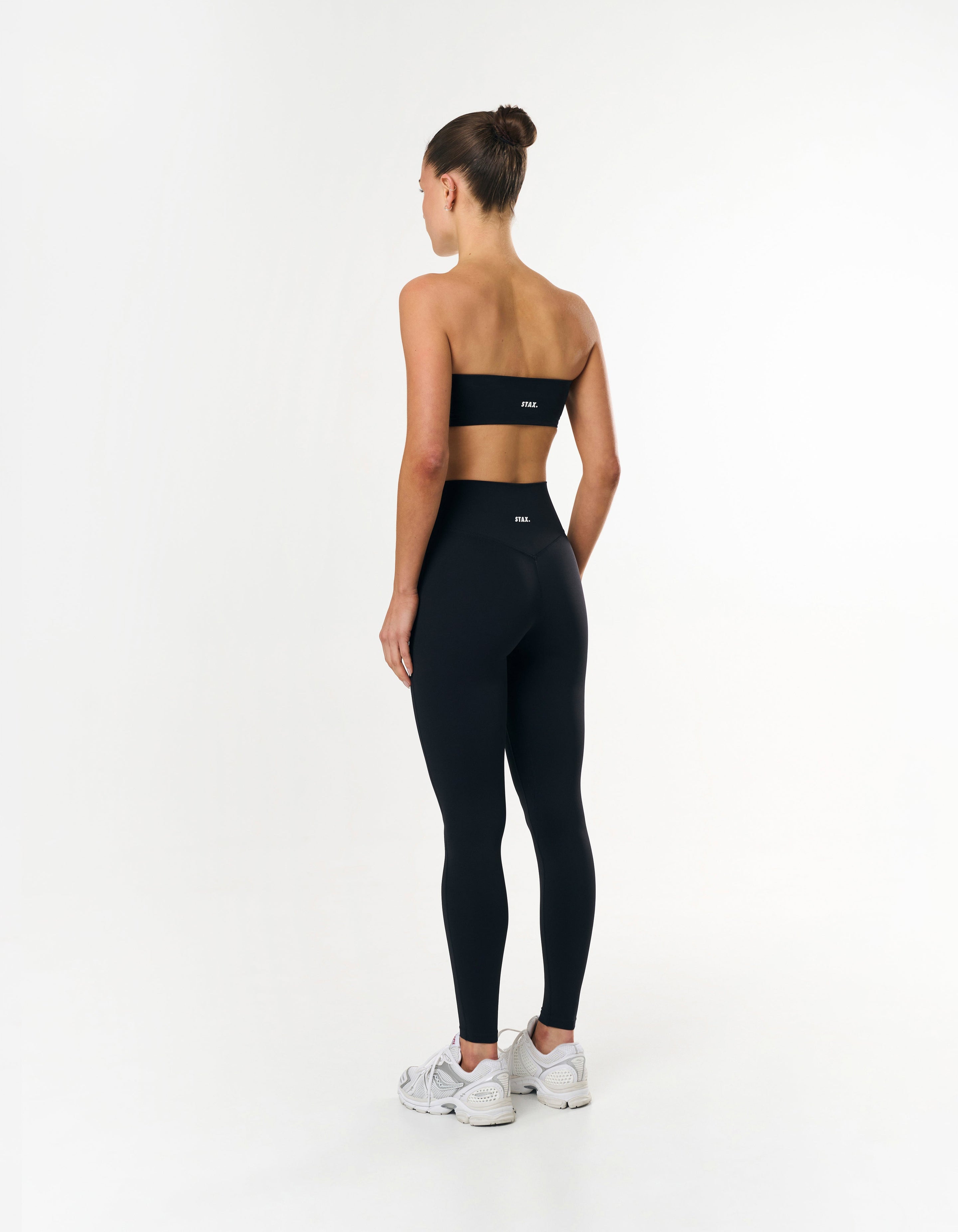 Back view of STAX. Full Length Tights Airlyte Black showing bandeau bra design with white STAX. logo