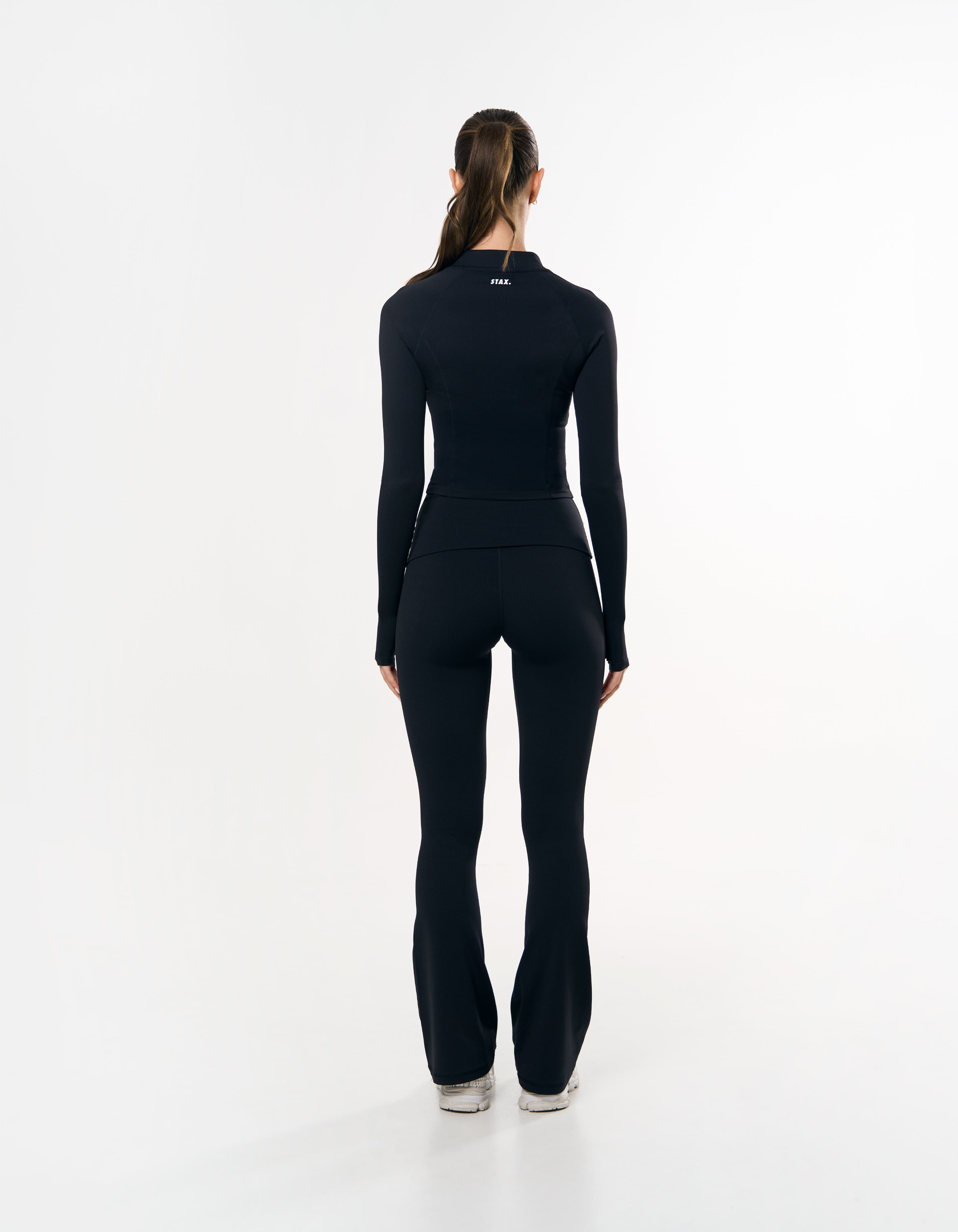 Back view of STAX. Zip Jacket Airlyte in Black showing white STAX. logo 