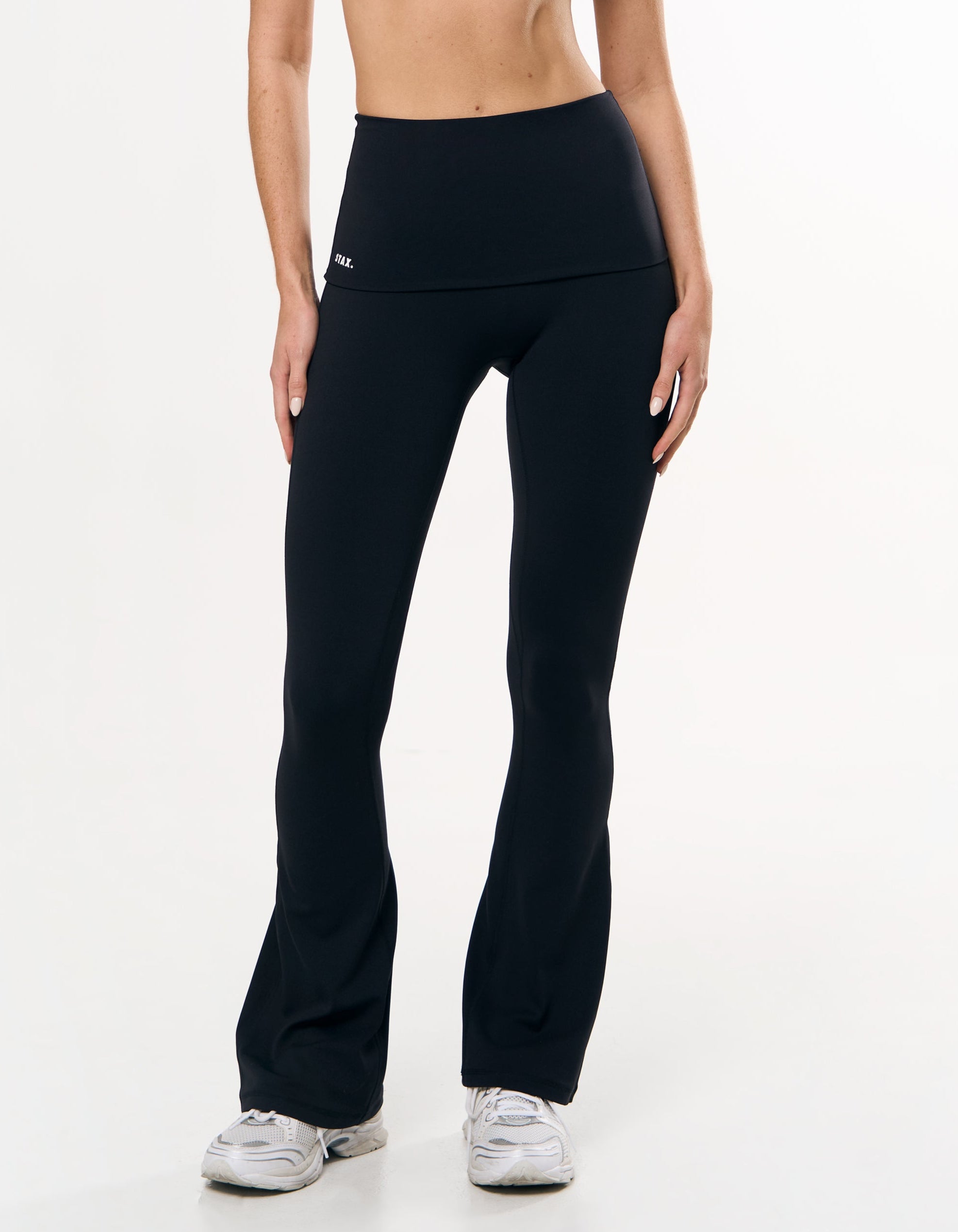 Front close up view of model wearing STAX. Fold Over Flares in Black