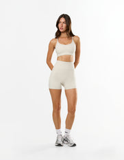 Front view of model wearing STAX. NFS Midi Bike Shorts NANDEX™ in Oat with high waist flattering fit