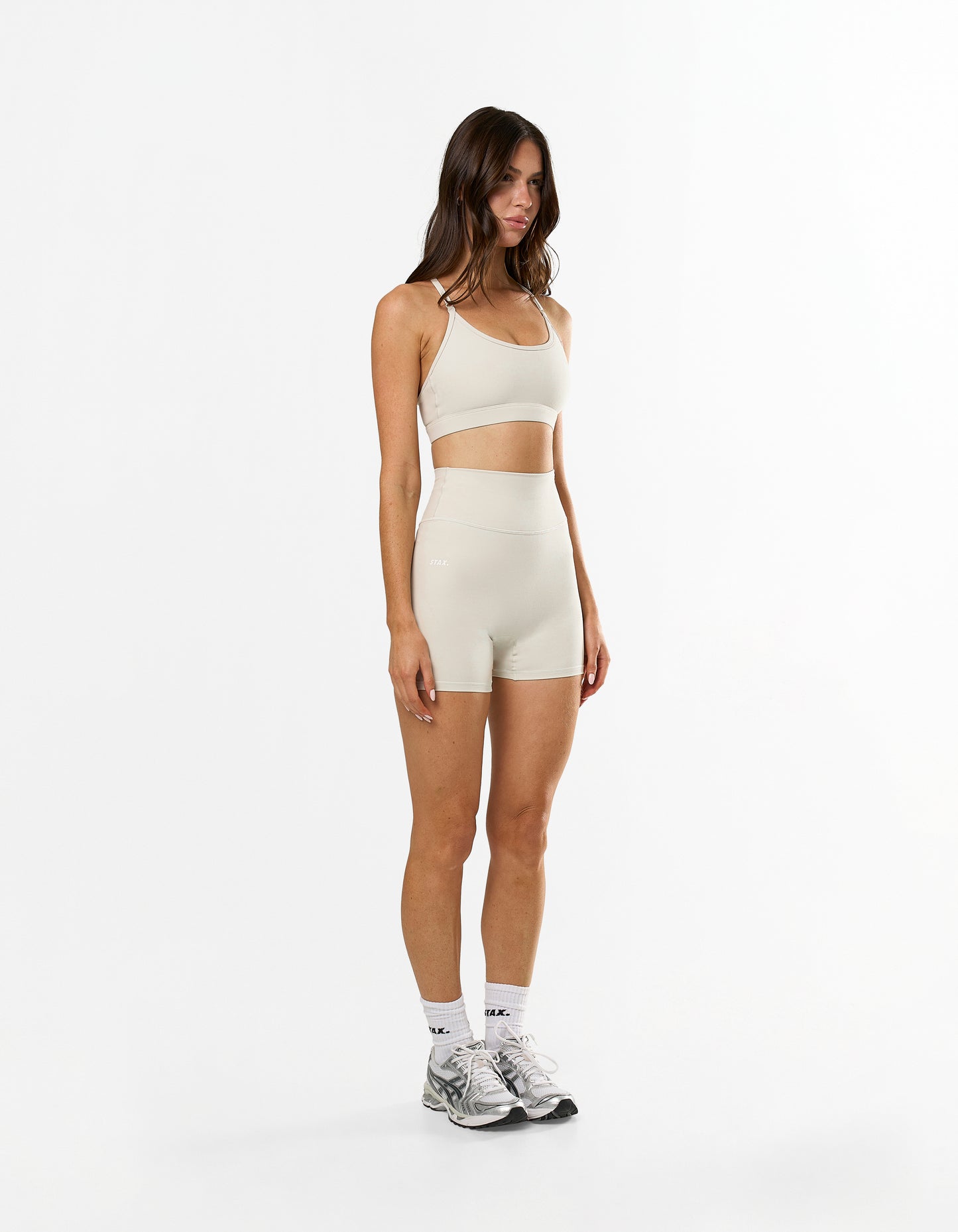 Side profile of STAX. NFS Midi Bike Shorts NANDEX™ in Oat showing flattering fit with no front seam