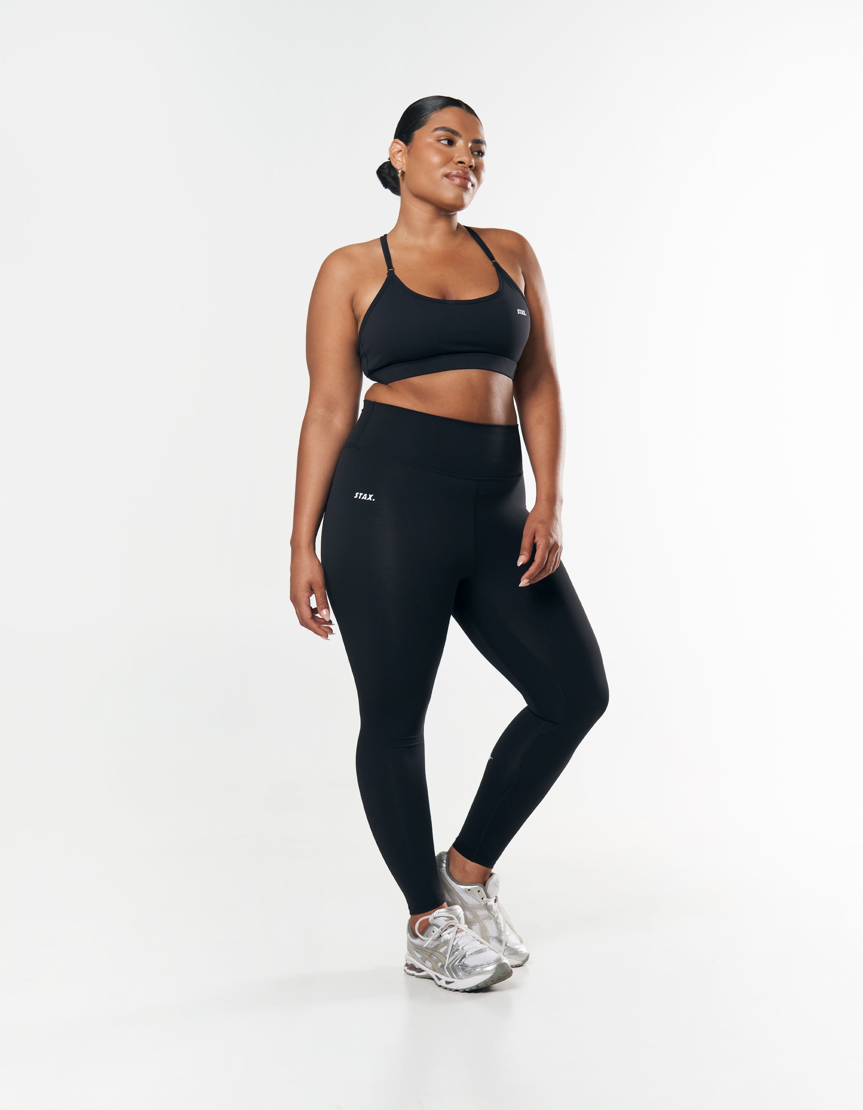 Front view of model wearing STAX. Full Length Tights NANDEX™ Original in Black with matching sports bra with Curve model