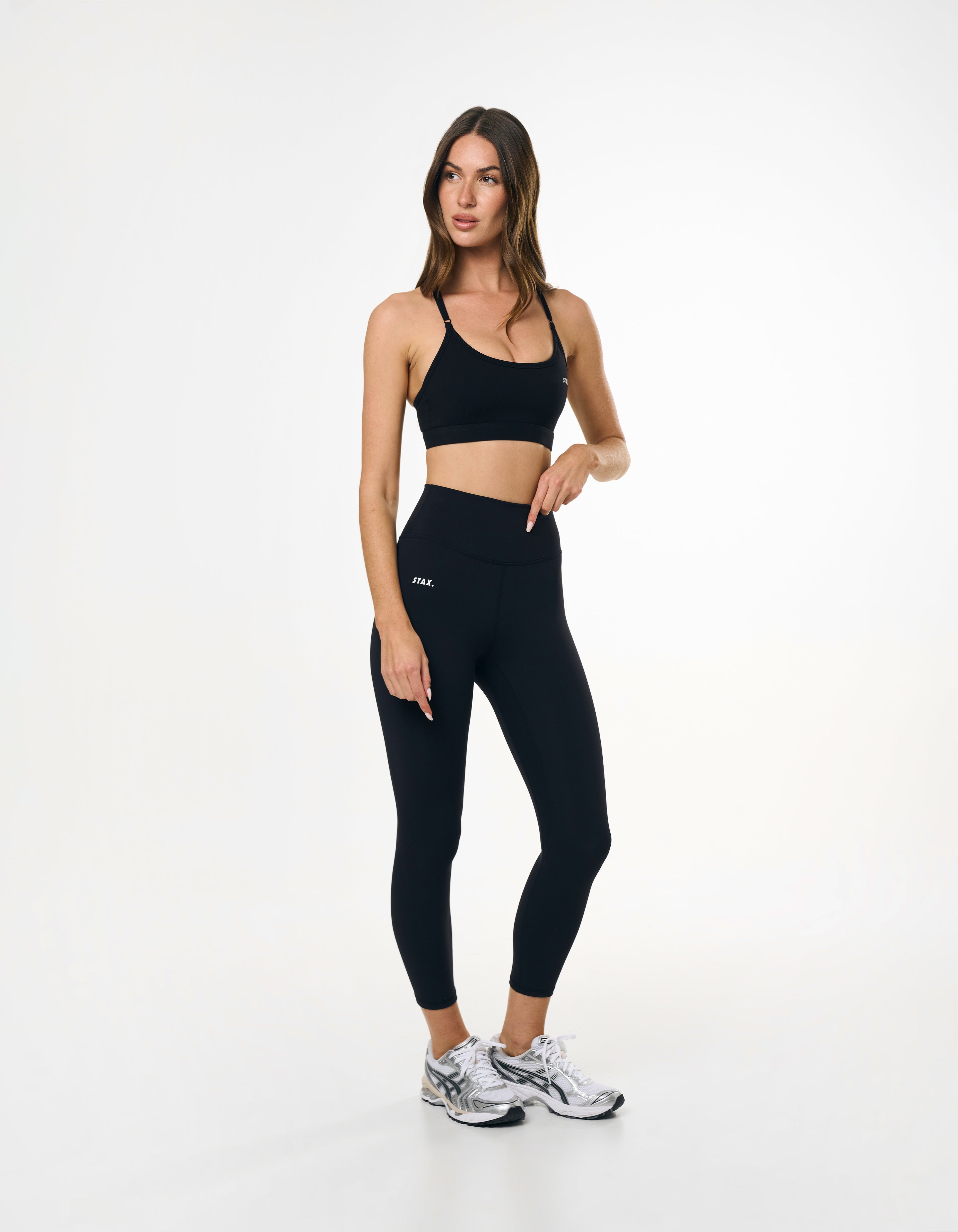 Side view of high waisted black tights showing glute contour and seamless front