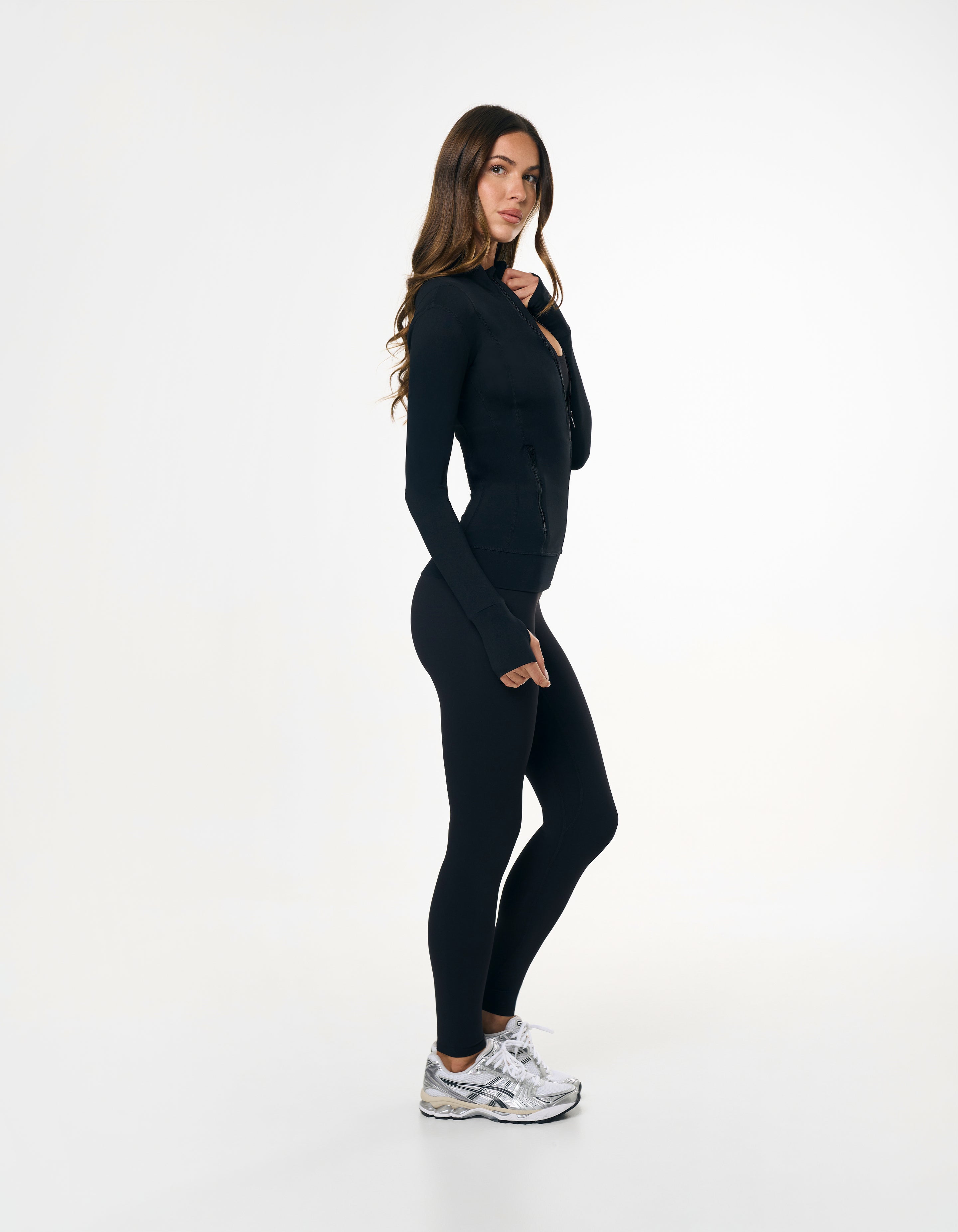 Side profile of STAX. Zip Jacket NANDEX™ in Black showing flattering tight fit